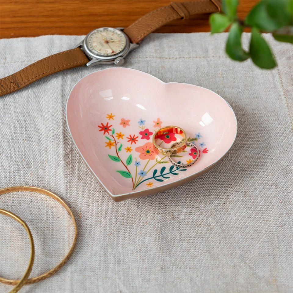 Pink heart-shaped flower trinket dish holding rings, lifestyle shot