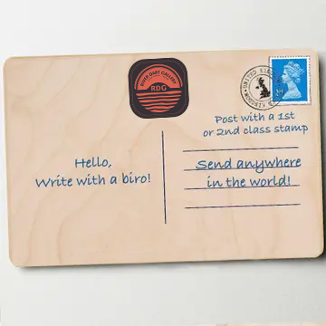 Back of the Stoke Gabriel wooden postcard, showing the River Dart Gallery stamp, writing lines, and postage guidance