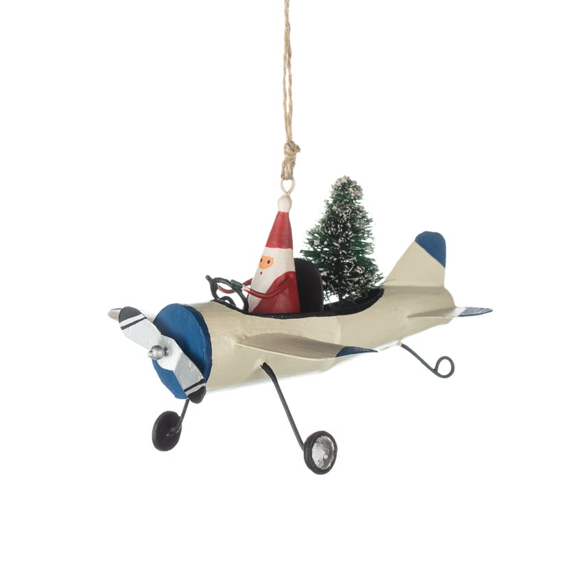 Santa in a plane delivering a tree